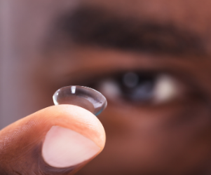 Man holding contact lenses