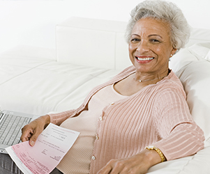 Middle aged woman on couch smiling